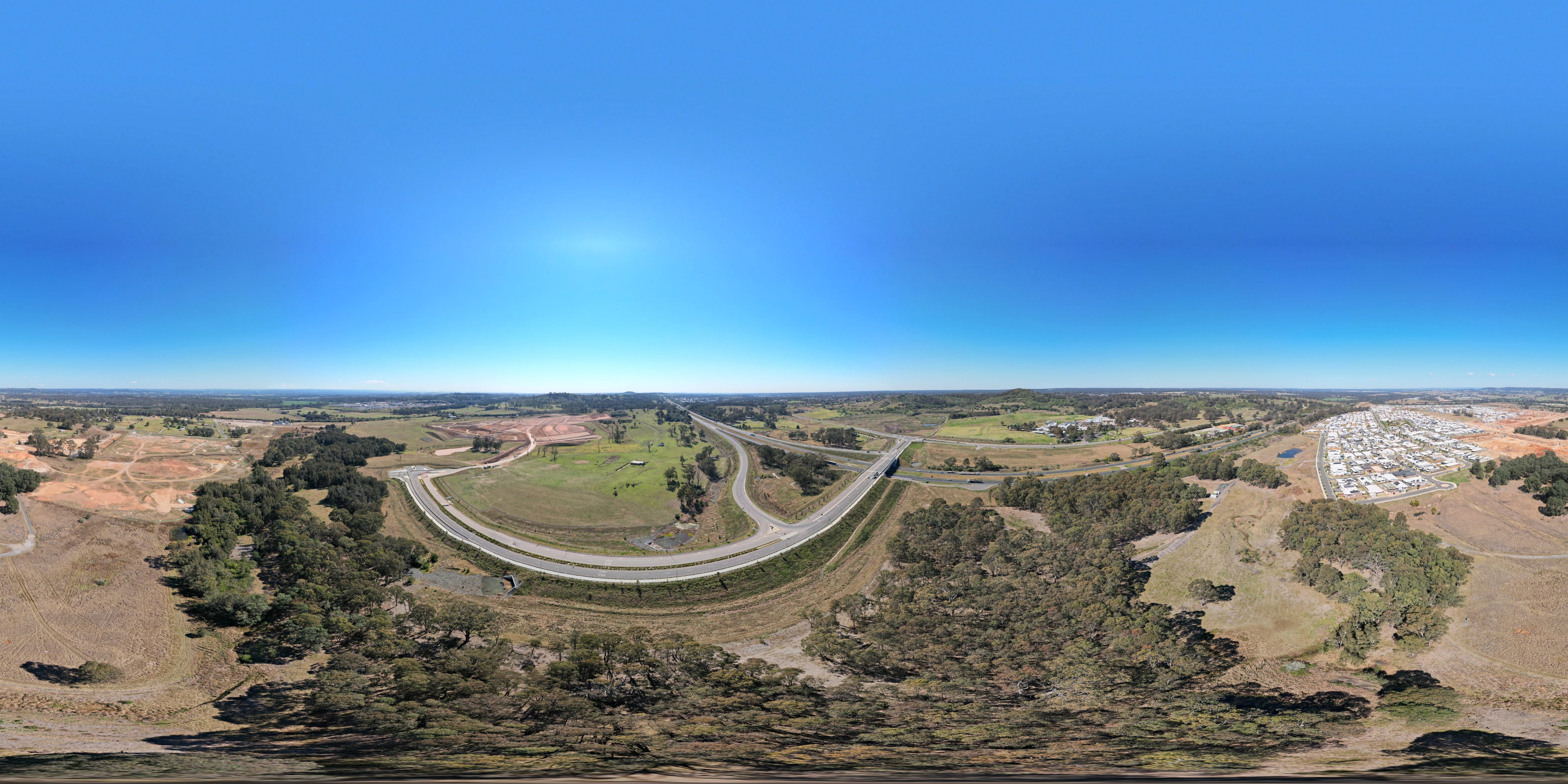 The north-east corner of the release area, where Spring Farm Parkway runs up to the Hume. The ramps here face the city only; there is no southbound connection.