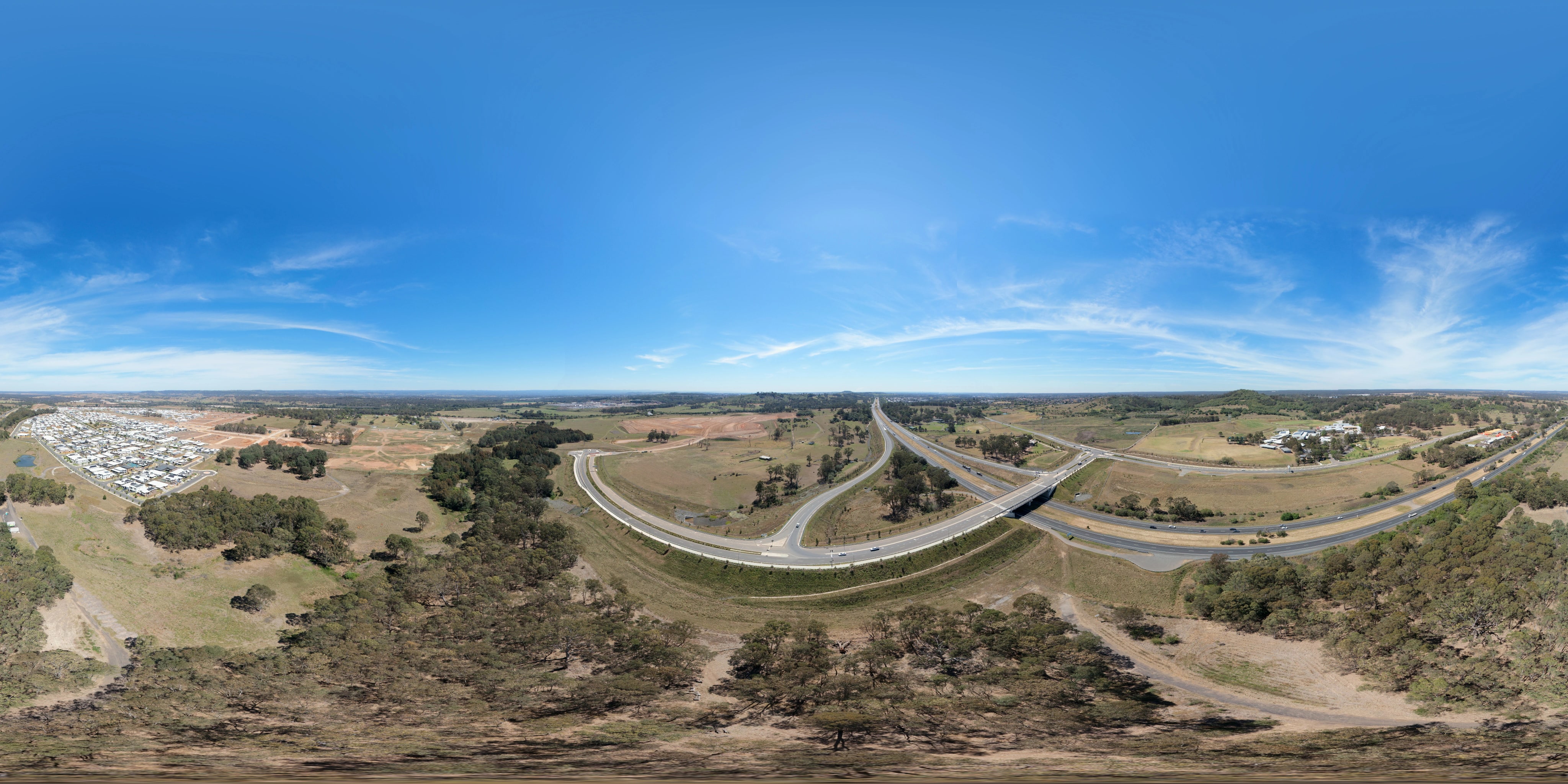 Road ramps, a divided road and surrounding trees.