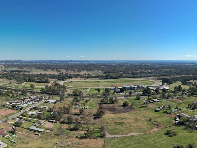 Over the older houses on Cummins Road and Payten Street, with the harness track beyond them and the new estate rising on the other side.
