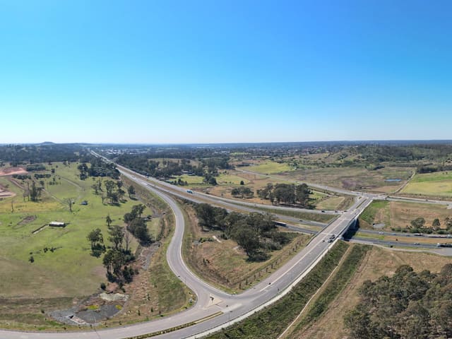 The north-east corner of the release area, where Spring Farm Parkway runs up to the Hume. The ramps here face the city only; there is no southbound connection.