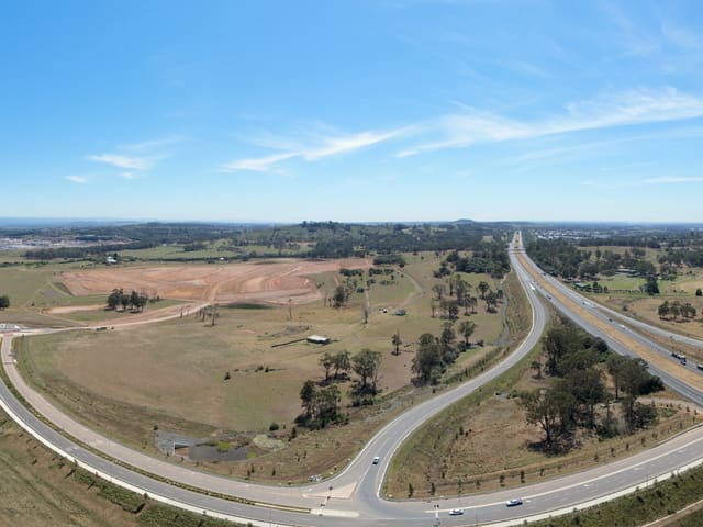 Road ramps, a divided road and surrounding trees.