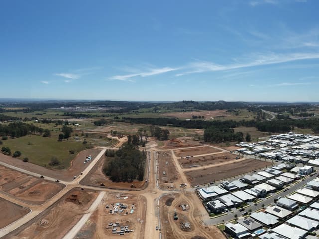 Rows of houses beside surfaced streets and earthworks.